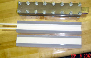 Top view of partially open injector showing the teflon rails and spacers.